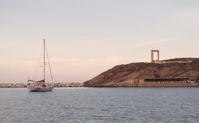 Arbutus anchored outside of Naxos town with Portara (gateway to Apollo's temple) in the background.