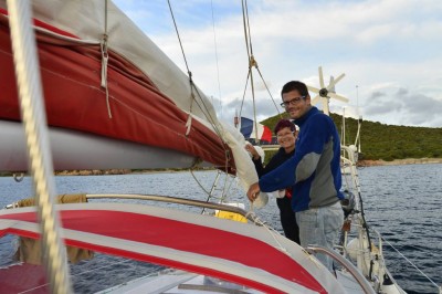 Paul getting some sewing tips to repair the main sail at Cala di Furnellu, Corsica