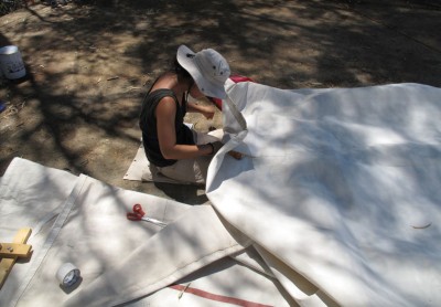 Hard working Canadian hand sewing the sails