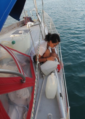 Filling up our water tanks with our jerry cans.